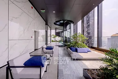 Luxurious high-rise building balcony with modern seating and stunning city views.