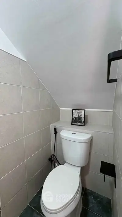 Compact modern bathroom with sleek design and efficient use of space.