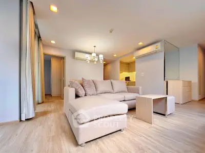 Spacious modern living room with cozy beige sofa and elegant lighting