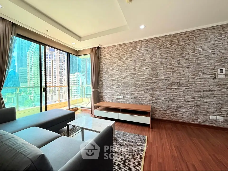 Spacious modern living room with city view and stylish stone accent wall