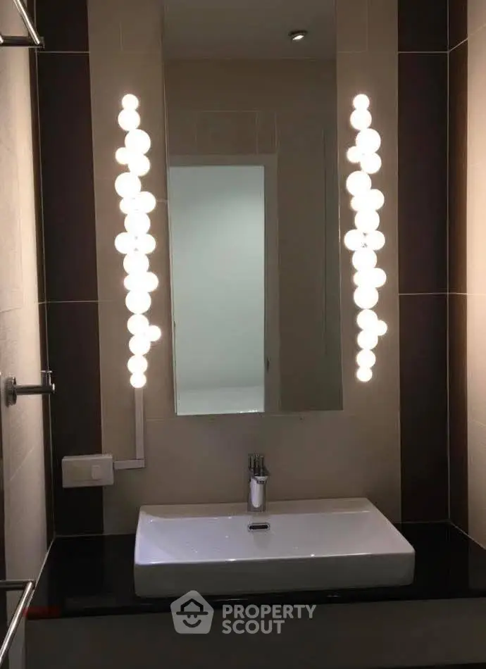 Modern bathroom with stylish lighting and sleek sink design.