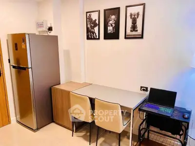 Modern kitchen corner with sleek fridge and stylish dining setup