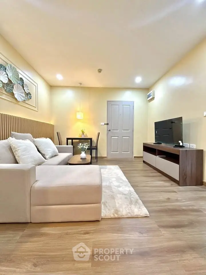 Modern living room with cozy sofa, elegant decor, and stylish dining area in open layout.