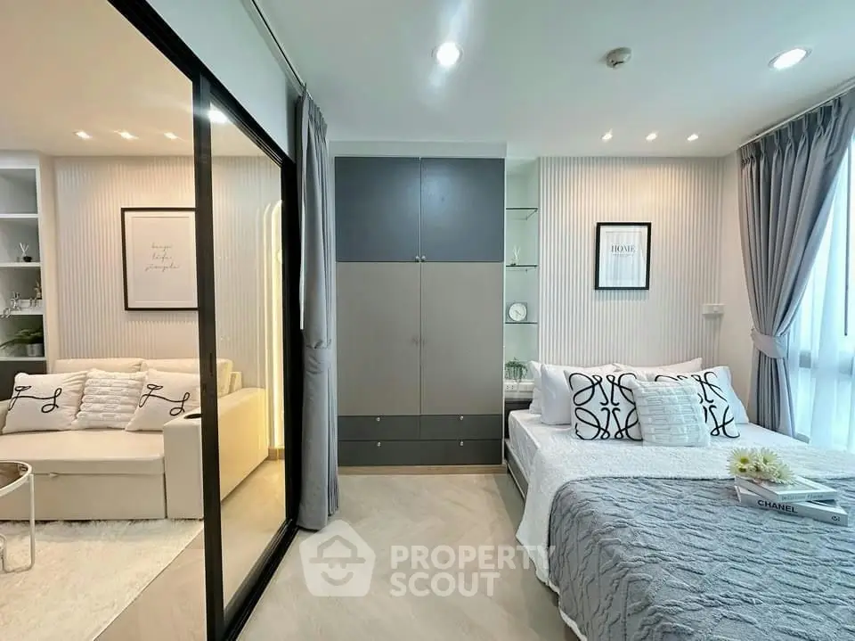 Modern bedroom with stylish decor and sliding glass partition in a cozy apartment.