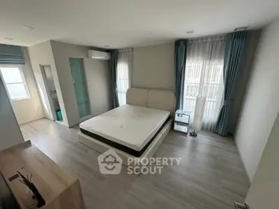 Spacious bedroom with modern decor and natural light