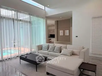 Luxurious modern living room with pool view and elegant decor