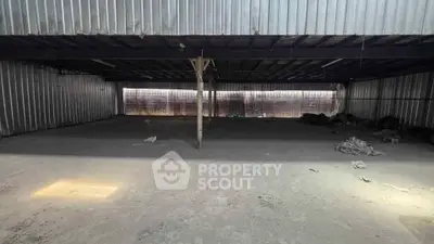 Spacious industrial warehouse with metal walls and ample storage space.