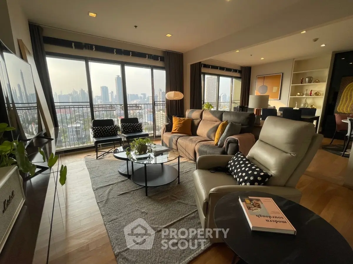 Spacious modern living room with city view, stylish furniture, and natural light.