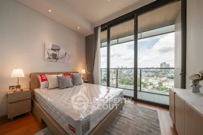 Luxurious bedroom with stunning city view from floor-to-ceiling windows and elegant decor.