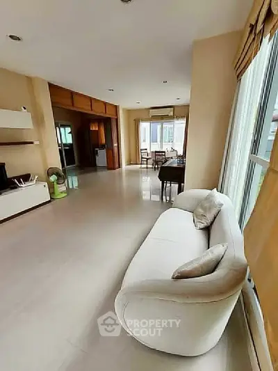 Spacious living room with modern decor and large windows for natural light.