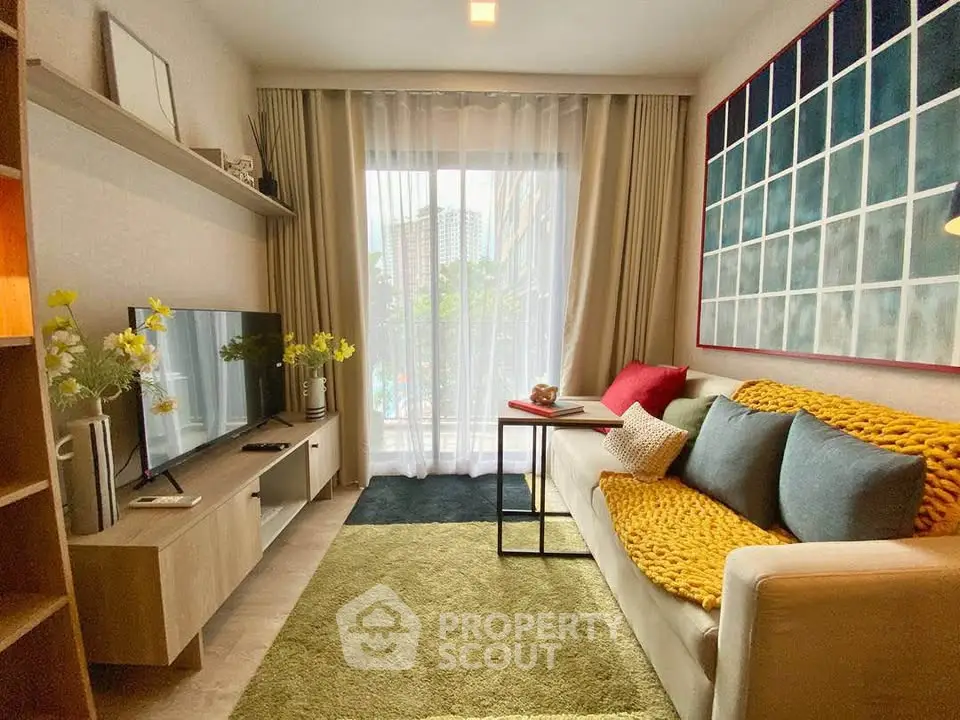 Cozy living room with modern decor, large window, and stylish furniture in a contemporary apartment.