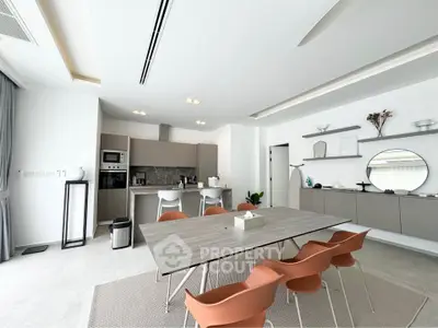 Modern kitchen with sleek design, open layout, and stylish dining area.