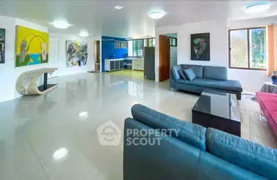 Spacious modern living room with stylish decor and open kitchen layout, perfect for entertaining.