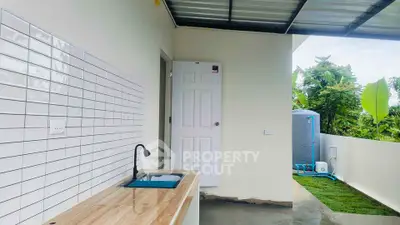 Modern outdoor kitchen with sleek countertop and garden view