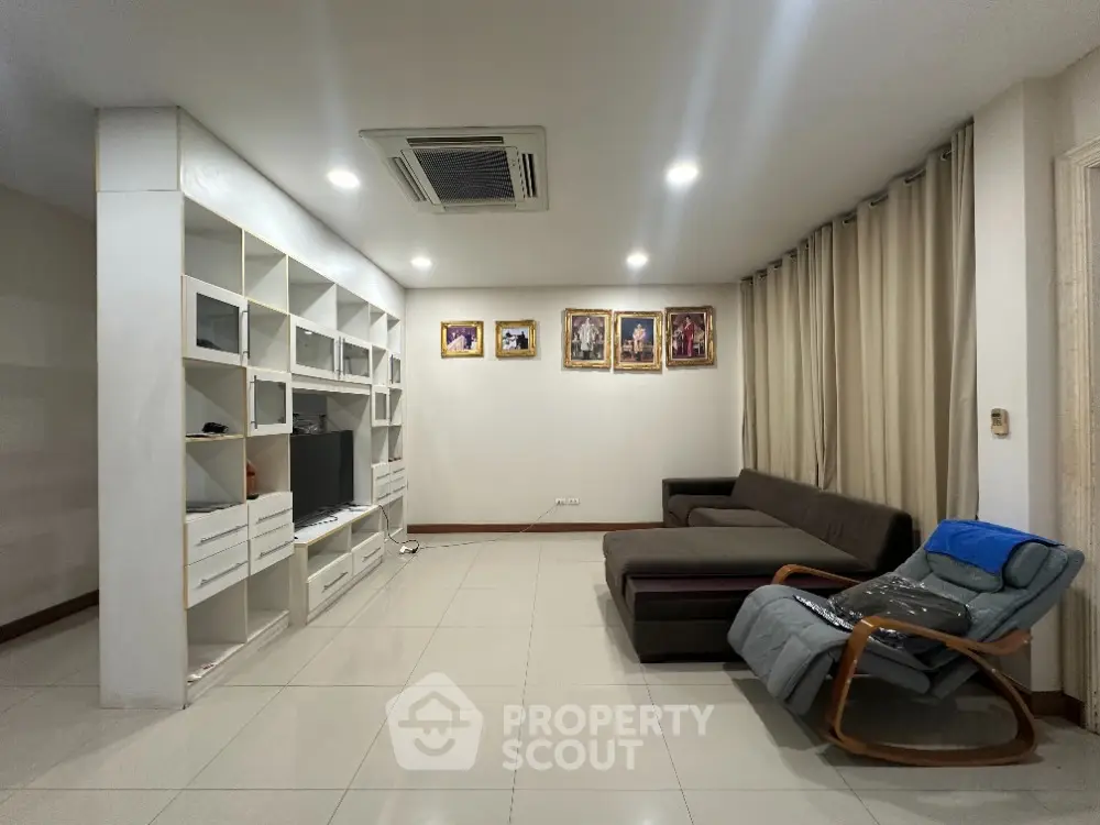 Spacious living room with modern furniture and built-in shelving