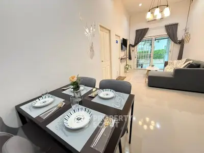 Modern living room with elegant dining area and stylish decor, perfect for contemporary living.