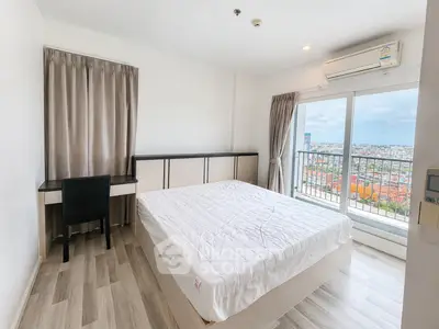 Bright bedroom with city view, featuring a large window and modern furnishings.