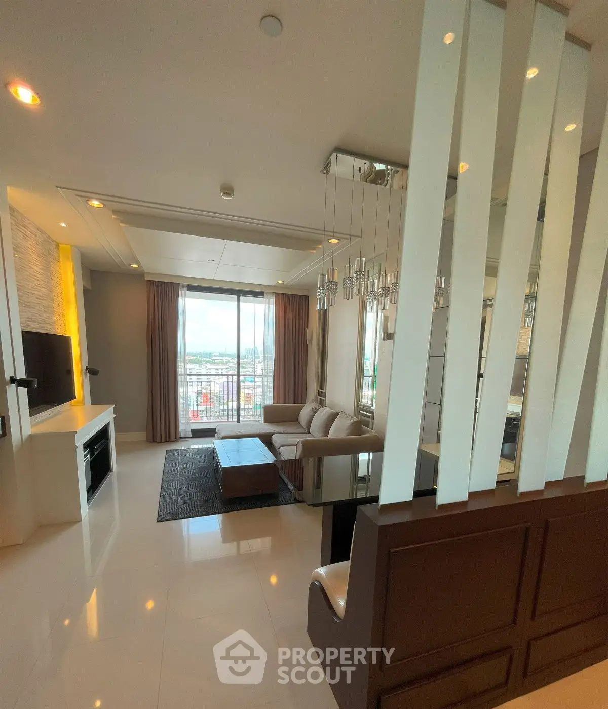 Luxurious living room with modern decor and stunning city view.