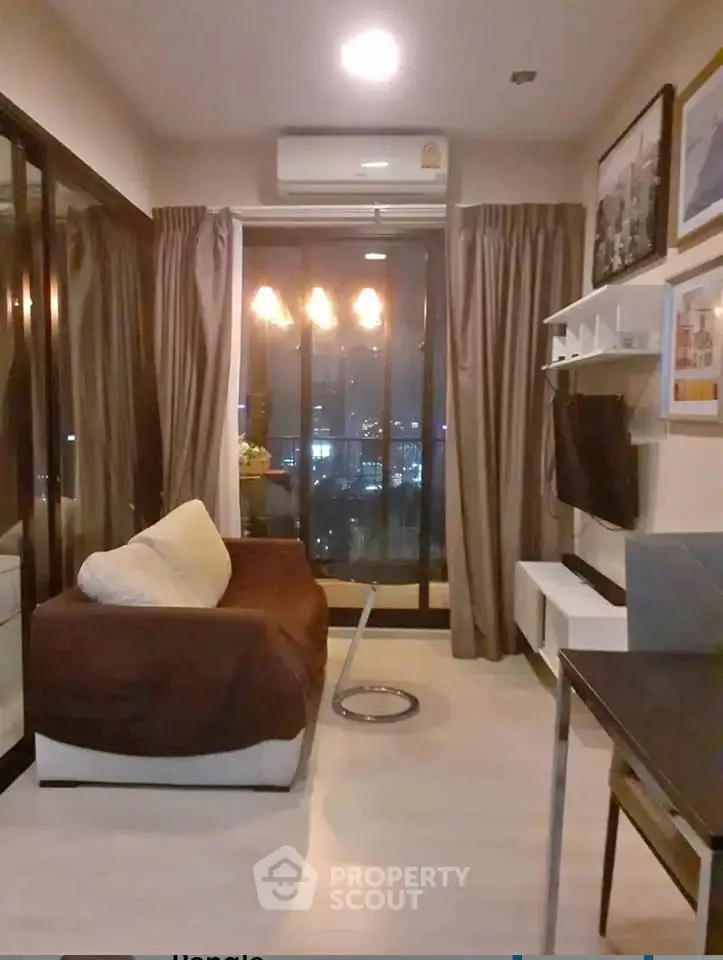 Modern living room with city view, cozy sofa, and stylish decor in a high-rise apartment.