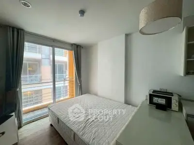 Modern bedroom with large window and natural light in urban apartment