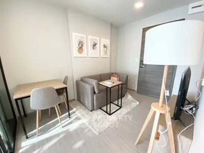Modern living room with stylish decor and natural light, featuring a cozy sofa and elegant dining area.