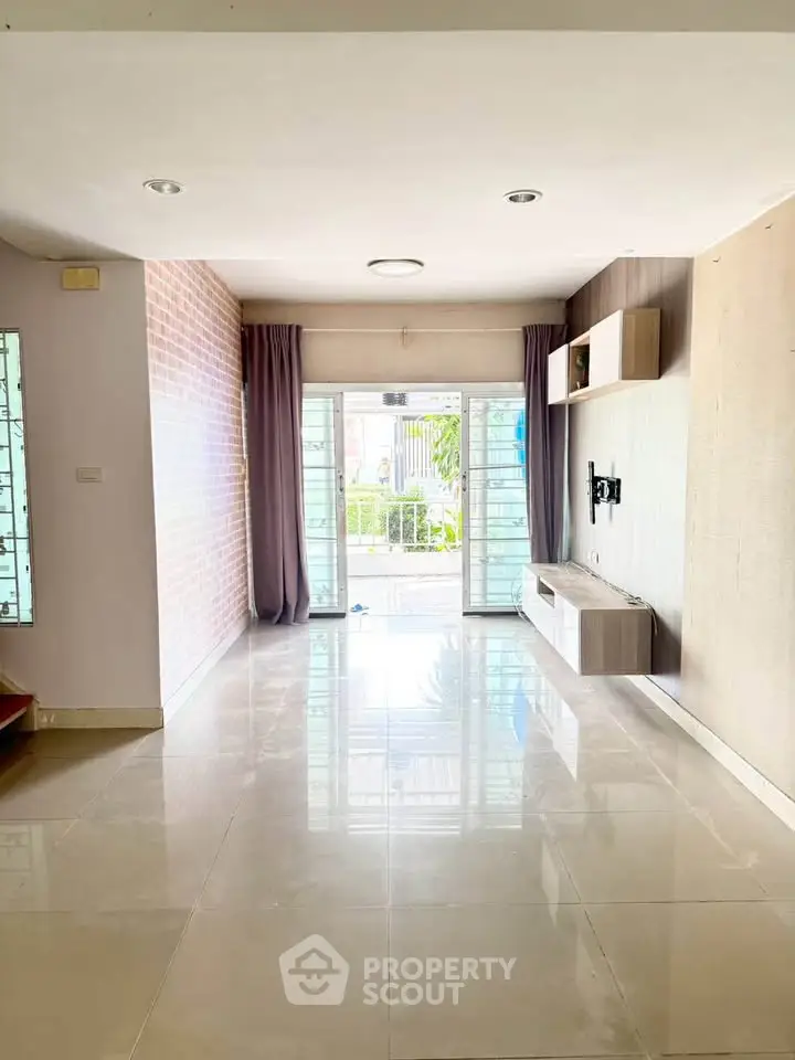 Spacious living room with large windows and modern decor