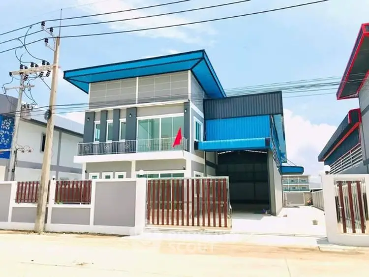 Modern industrial-style building with blue accents and spacious layout.