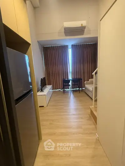 Modern studio apartment with wooden flooring and compact living area