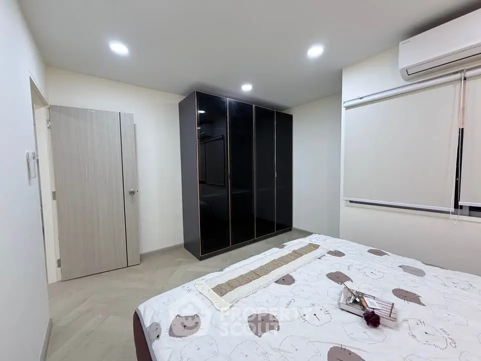 Modern bedroom with sleek wardrobe and cozy bed in minimalist design.