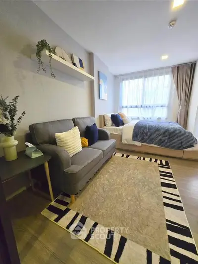 Modern studio apartment with cozy living area and stylish decor