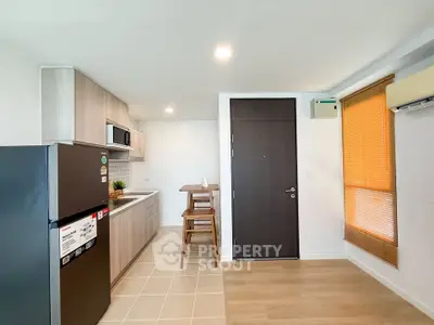 Modern kitchen with sleek cabinetry and dining area in a stylish apartment