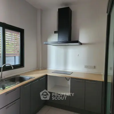 Modern kitchen with sleek cabinetry and induction cooktop
