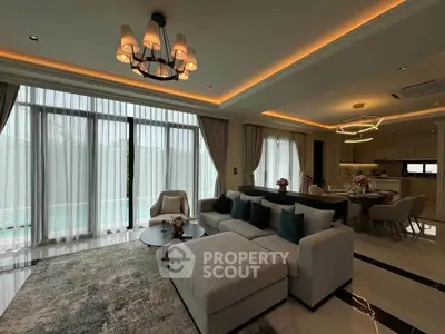 Luxurious open-plan living room with elegant decor and modern lighting