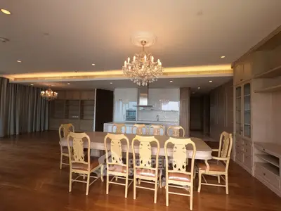 Luxurious dining room with elegant chandelier and spacious wooden flooring