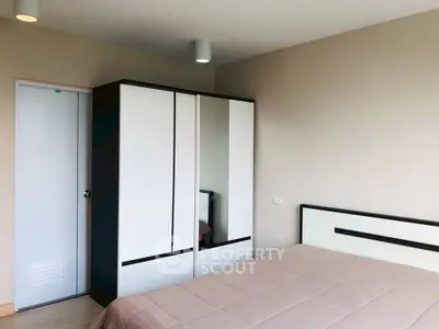 Modern bedroom with sleek wardrobe and cozy bed in a stylish apartment.