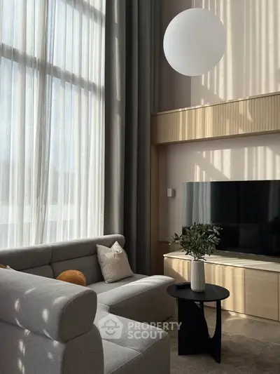 Modern living room with high ceilings and elegant decor