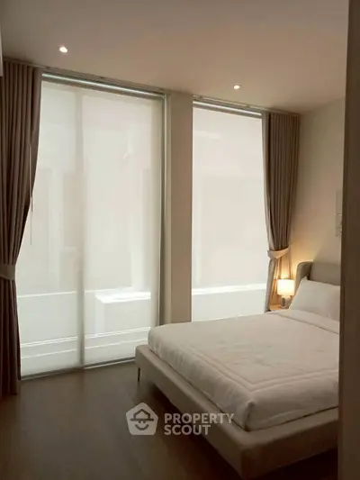 Elegant bedroom with floor-to-ceiling windows and modern decor
