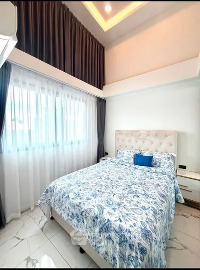Luxurious bedroom with high ceiling and elegant decor