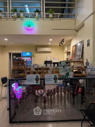 Charming interior with neon lights and modern decor in a cozy retail space.