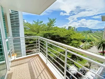 Spacious balcony with stunning mountain and garden views, perfect for relaxation and enjoying nature.