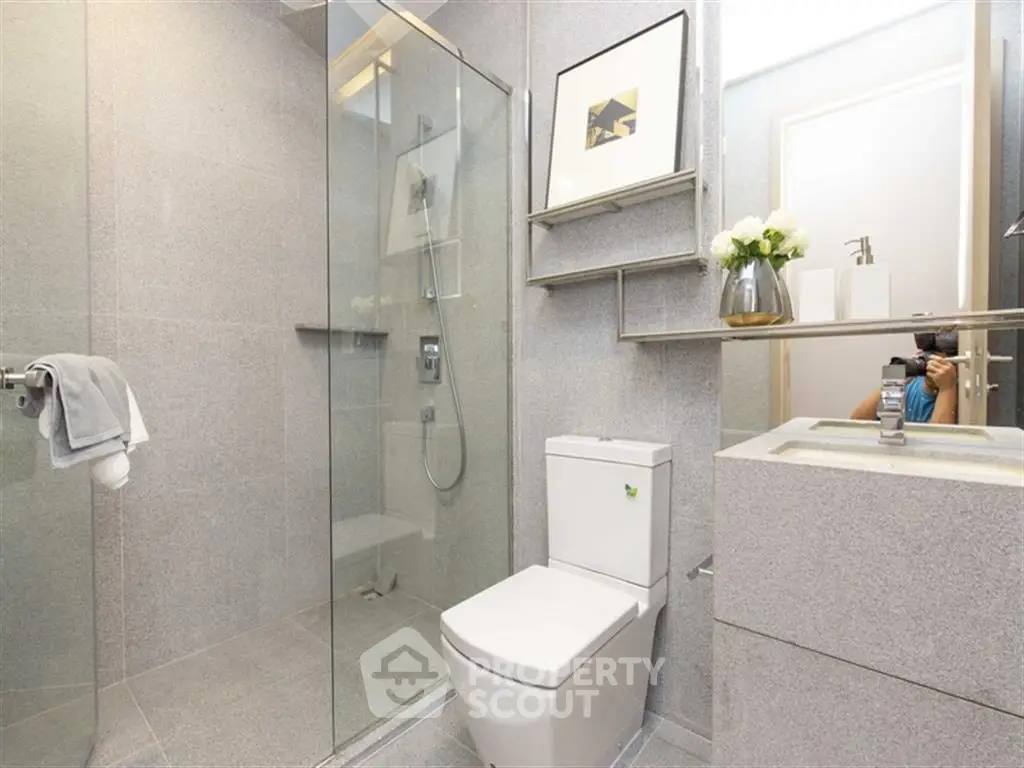 Modern bathroom with sleek design, glass shower, and elegant fixtures.