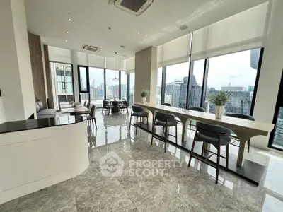 Luxurious open-plan living area with panoramic city views and elegant modern furnishings.