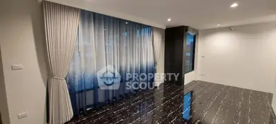 Elegant living room with stylish curtains and glossy flooring