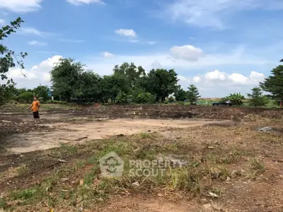 Spacious land plot with lush greenery and clear blue sky, perfect for development opportunities.