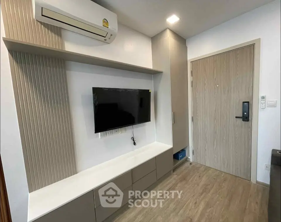 Modern living room with wall-mounted TV and sleek storage solutions