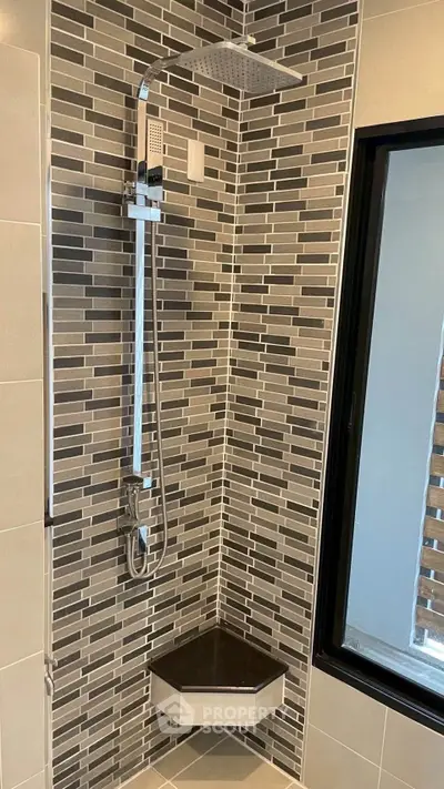 Modern bathroom shower with stylish tile design and corner shelf