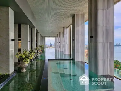 Luxurious rooftop pool with stunning city and ocean views, elegant design and serene ambiance.