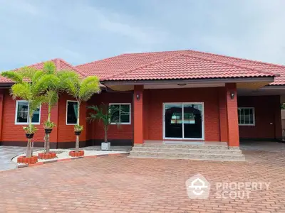 Charming red-brick house with tiled roof and spacious driveway