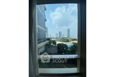 Stunning cityscape view from a modern apartment window, showcasing urban skyline and lush greenery.