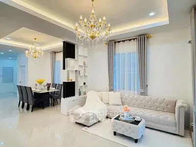 Luxurious living room with elegant chandeliers and plush seating in a modern open layout.